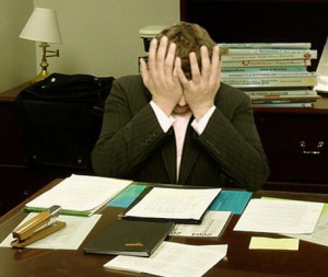 A man sitting at a desk looking frustrated